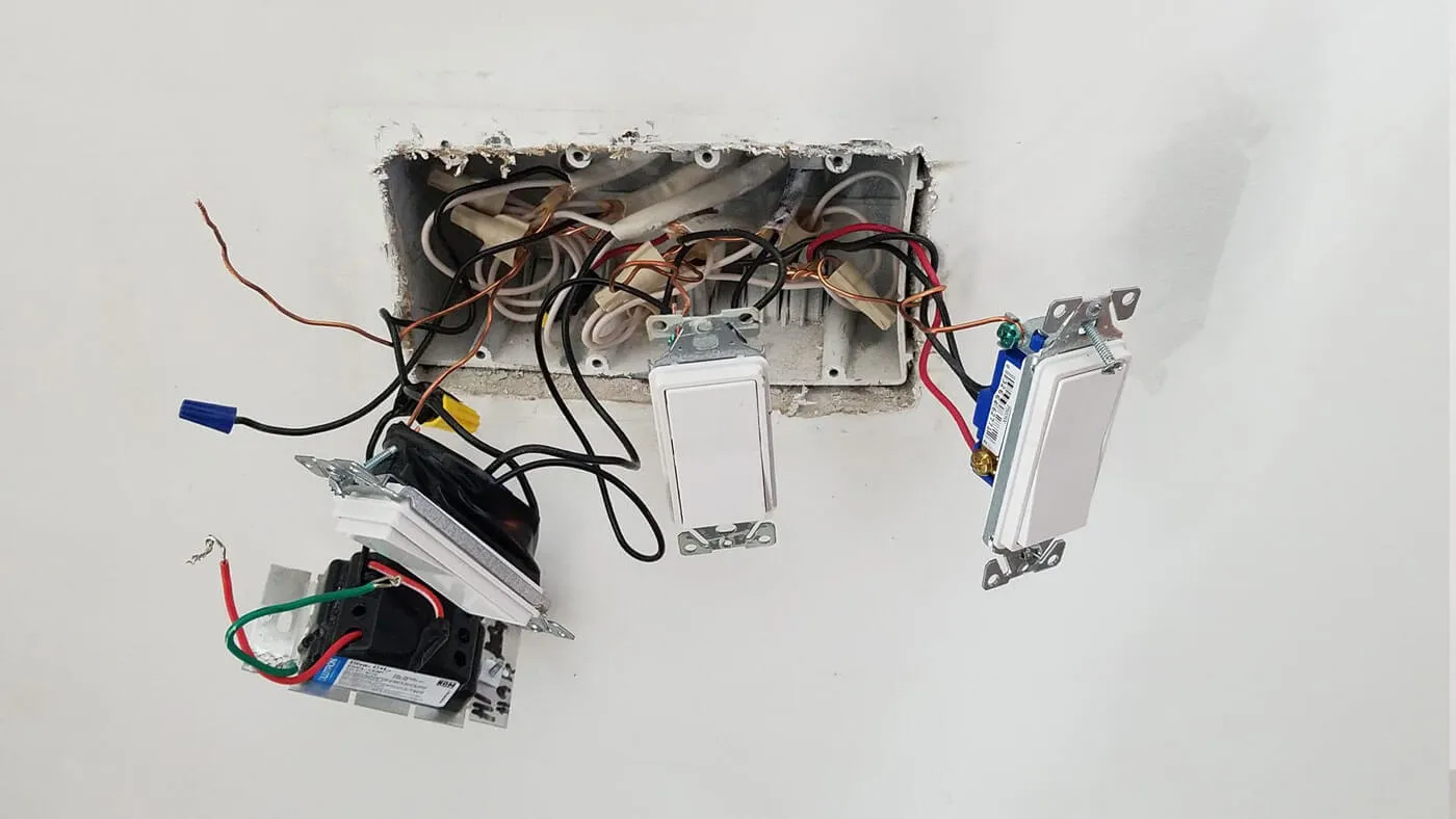 Exposed wiring behind a switch plate