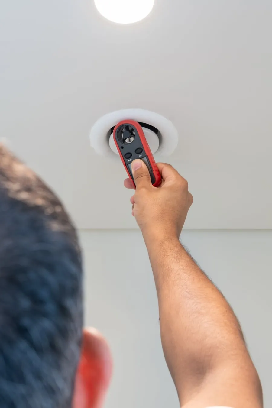 Anemometer measuring airflow at an AC vent